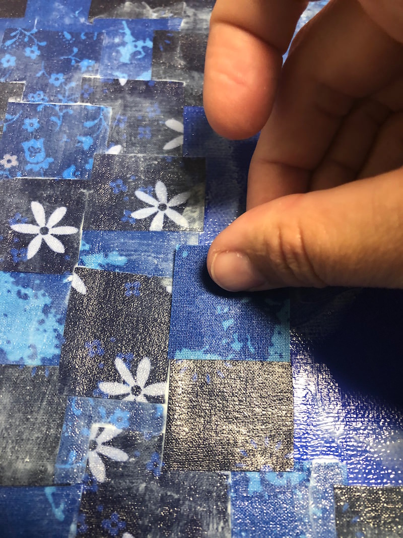 Placing down a blue fabric square