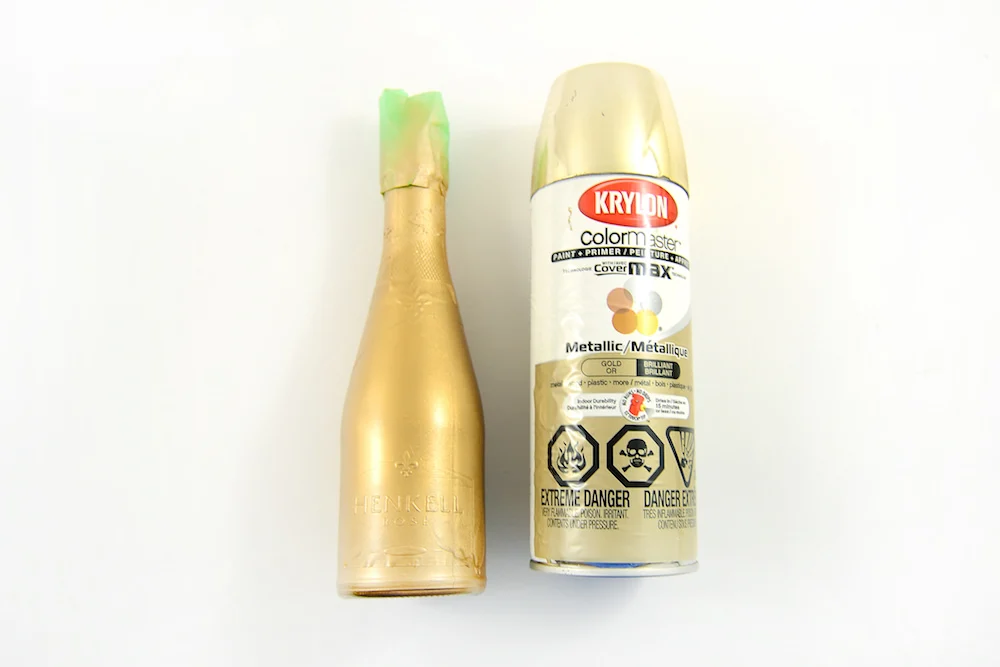 Spray paint the bottle with gold