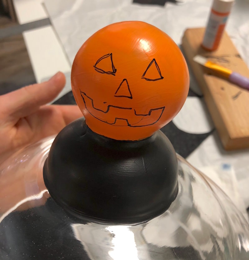 Draw a jack o lantern face with a sharpie