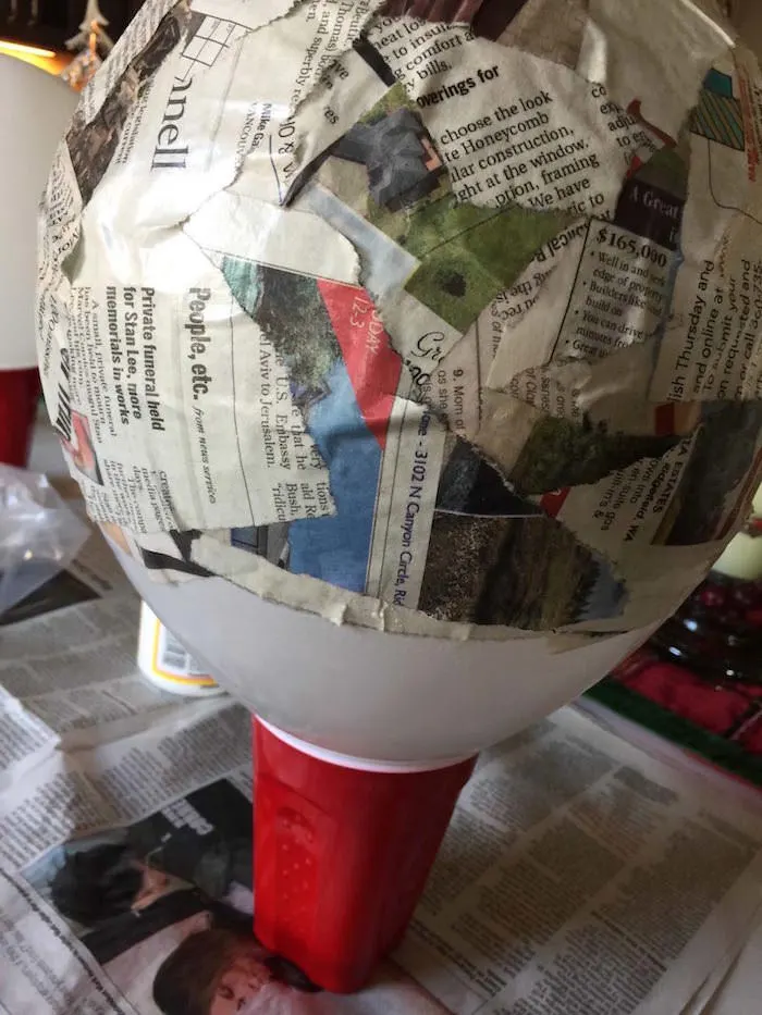 Dried newspaper strips on a balloon