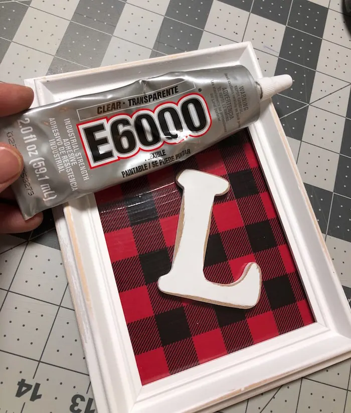 Glue the wood letter to the Duck Tape