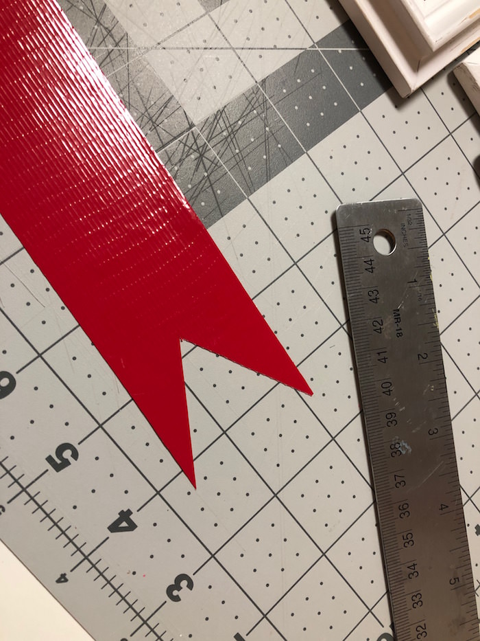 Cut a V shape in the bottom of the main strip