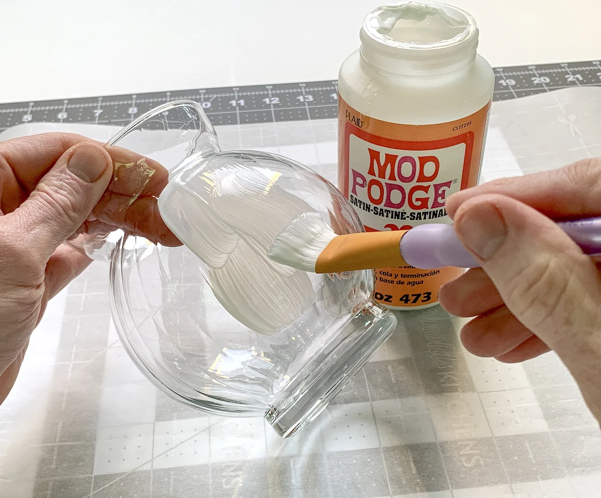 Painting Mod Podge on the outside of a glass jar