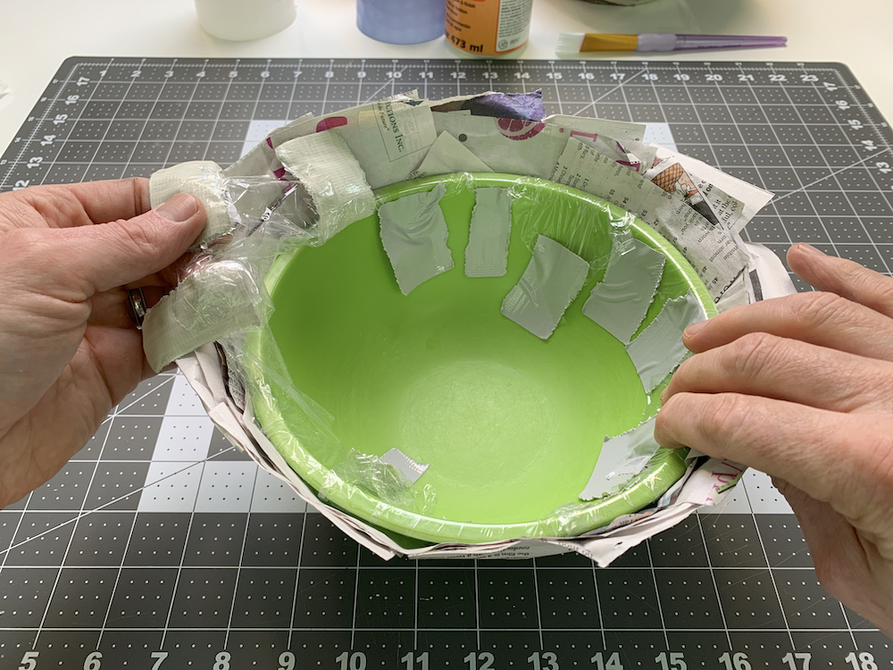 Removing the tape and newspaper from the bowl