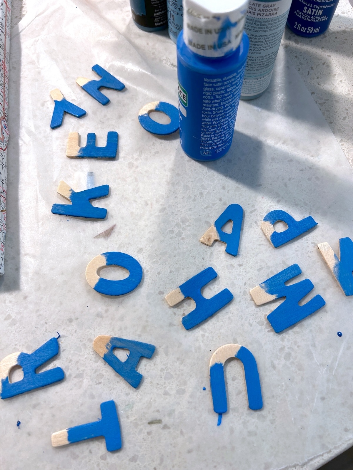 Painting wood letters with blue paint