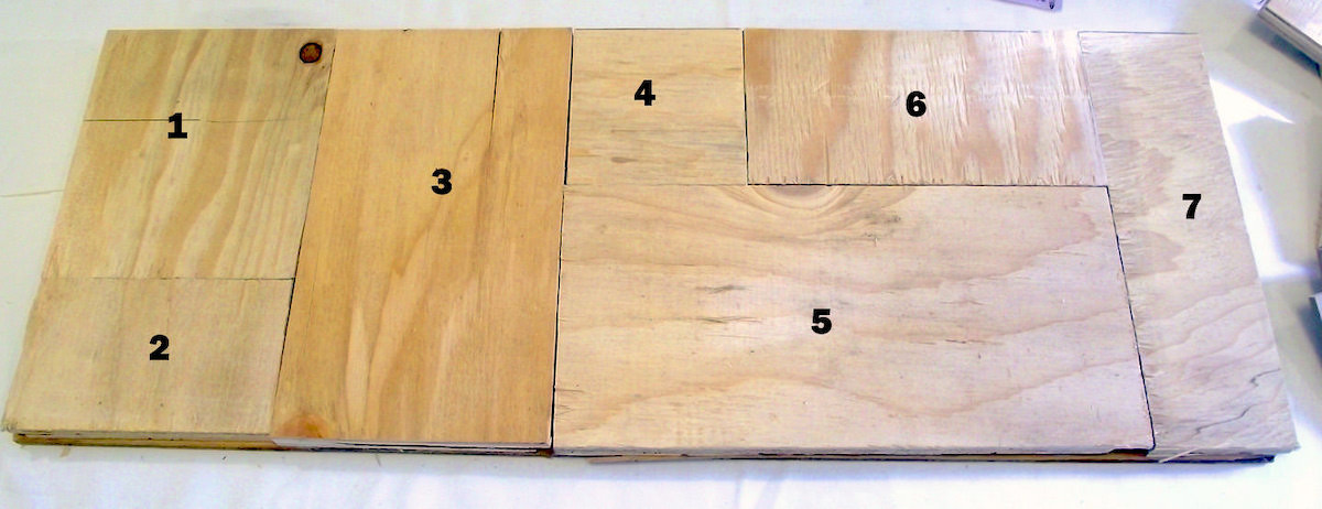 Scrap wood pieces organized on a backer board