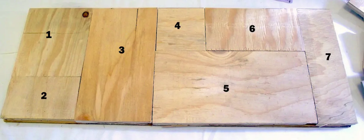 Scrap wood pieces organized on a backer board
