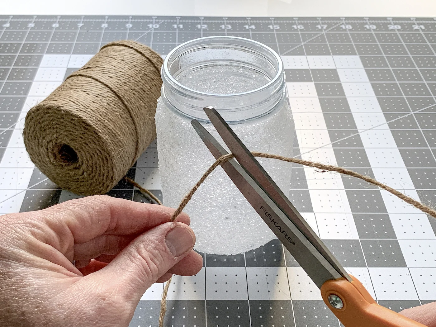 Cutting a piece of twine with a pair of scissors