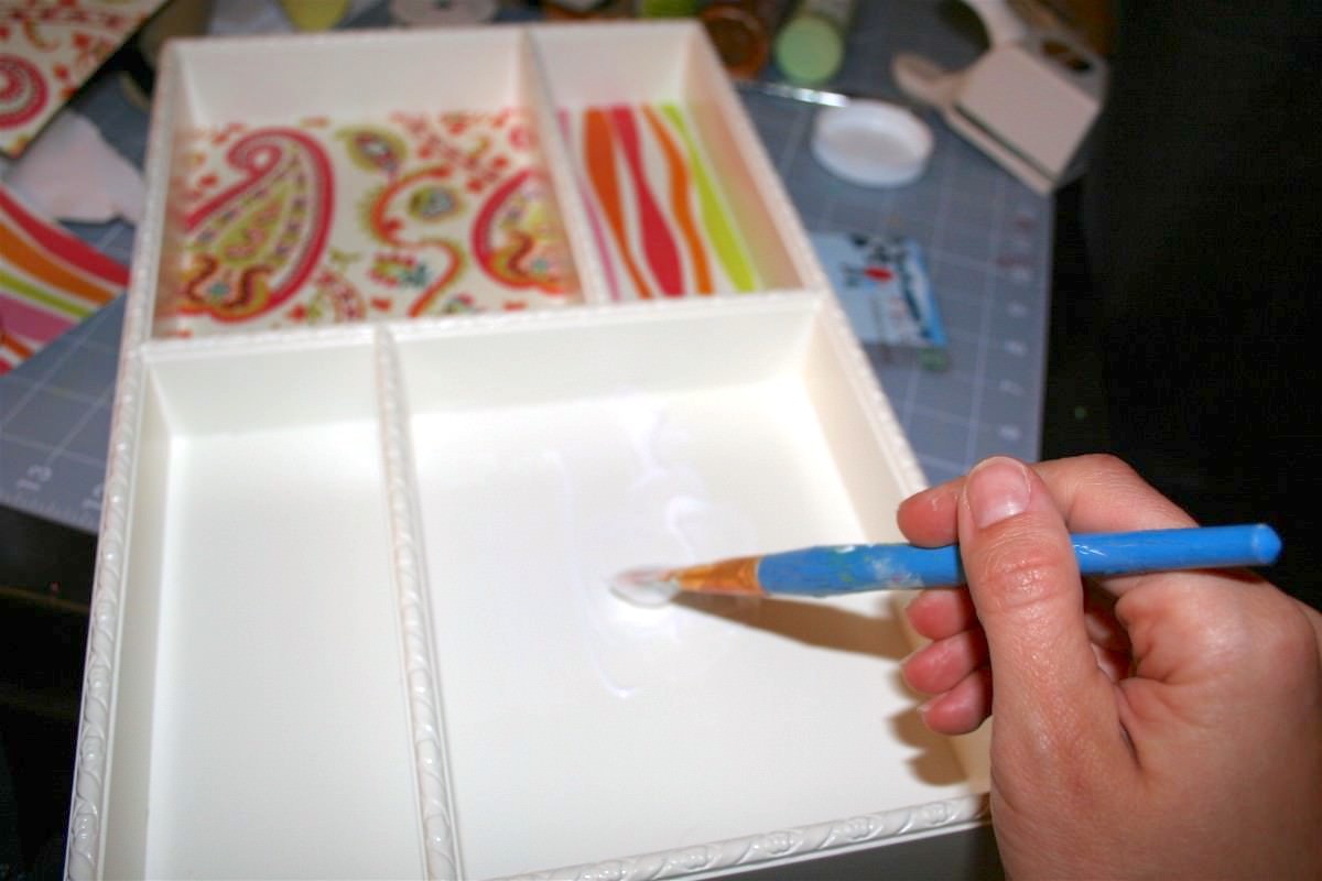 Adding Mod Podge to the bottom of the tray with a paintbrush