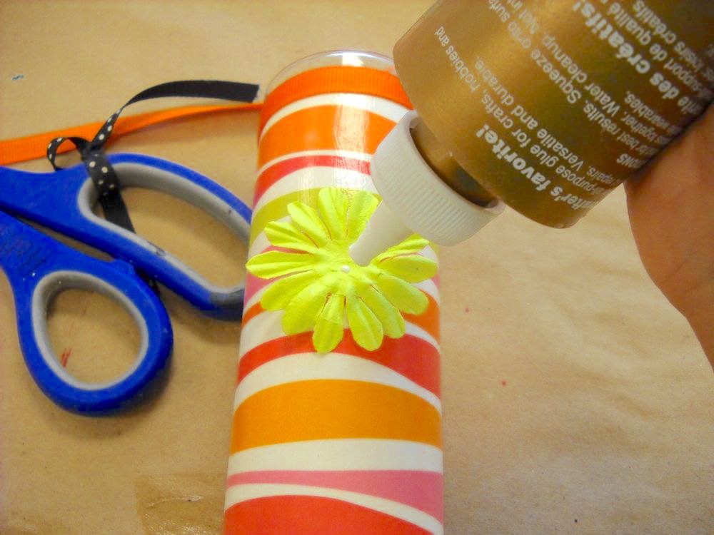 Adding flowers and buttons with craft glue