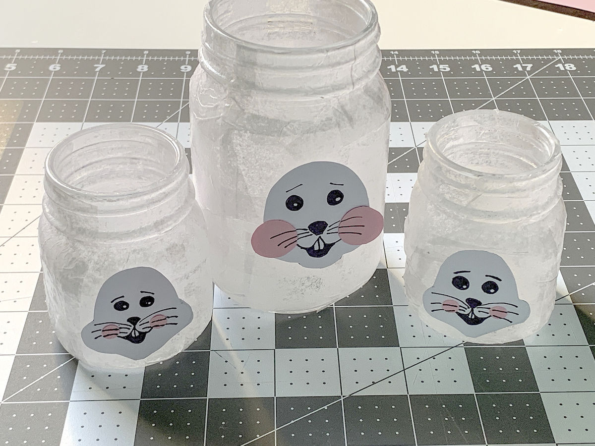 Easter bunny faces on the sides of three mason jars