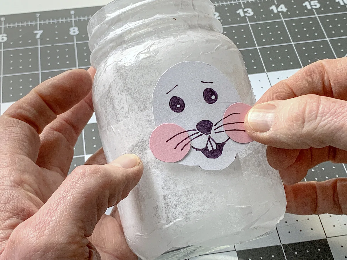 Placing the Easter bunny face down on the mason jar