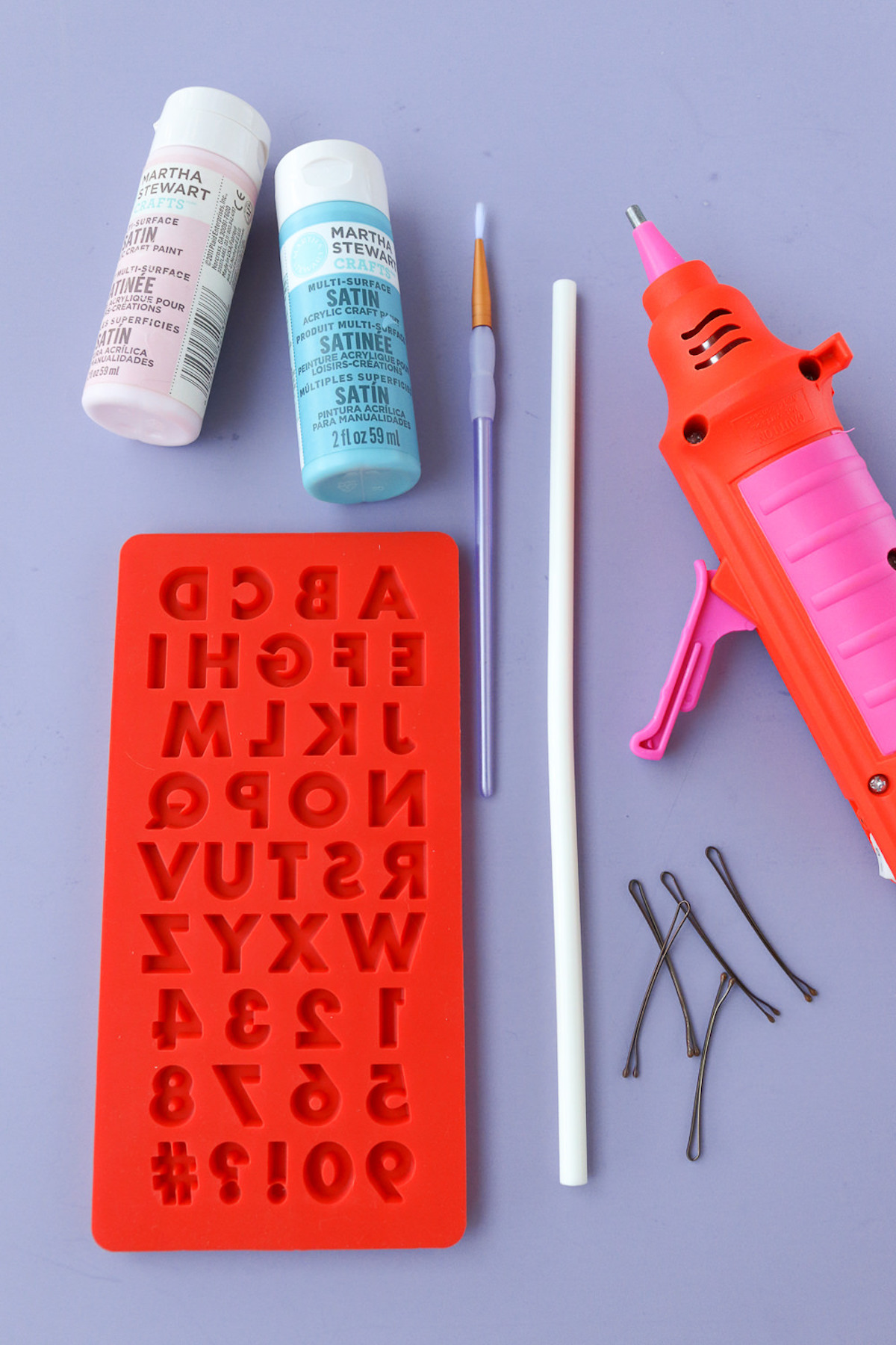 Silicone mold, paint, paintbrush, glue gun, glue stick, and bobby pins