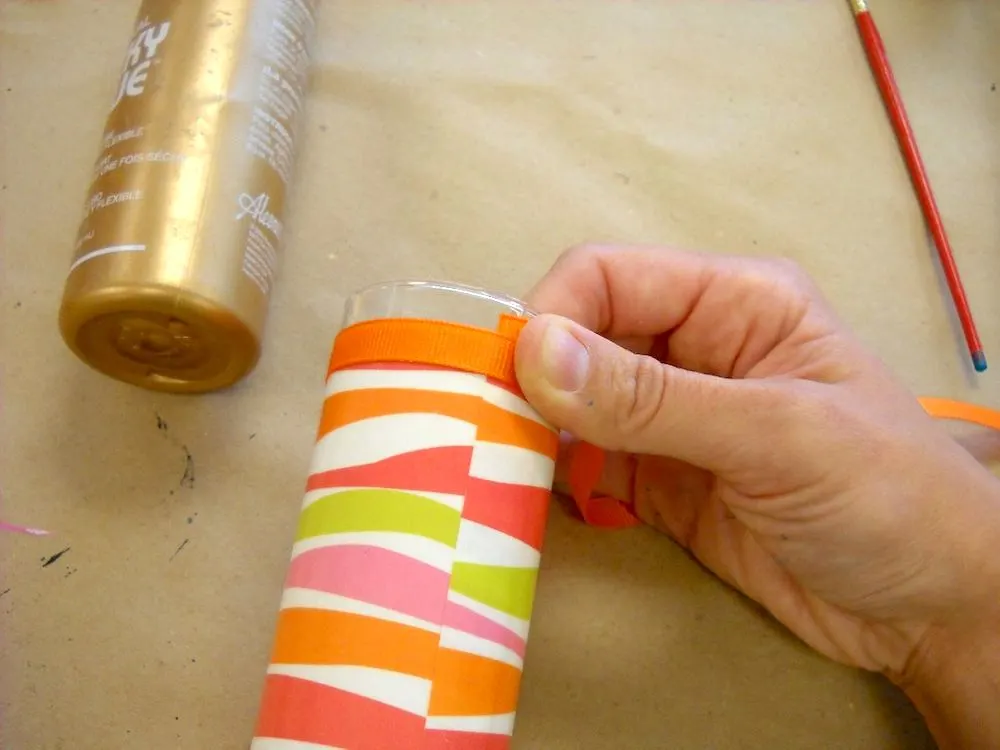 Use the craft glue to adhere the ribbon to the top and bottom