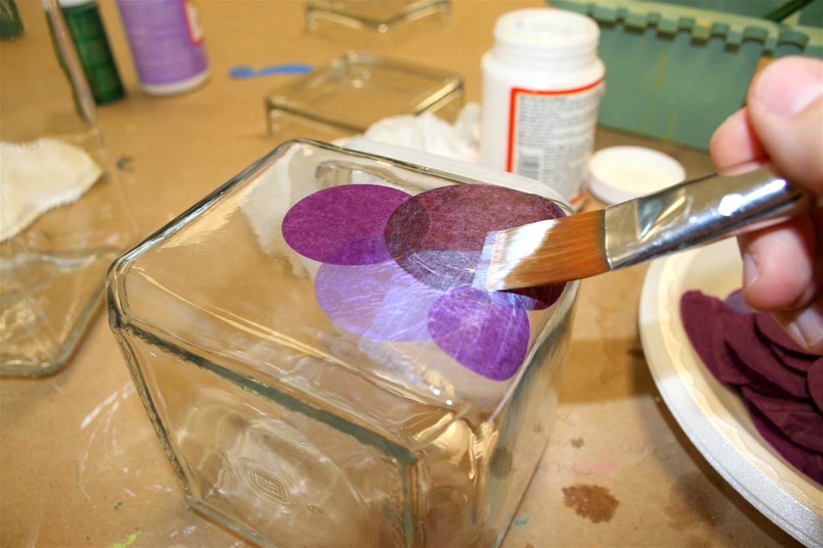 Adding purple circles to the glass jar with Mod Podge