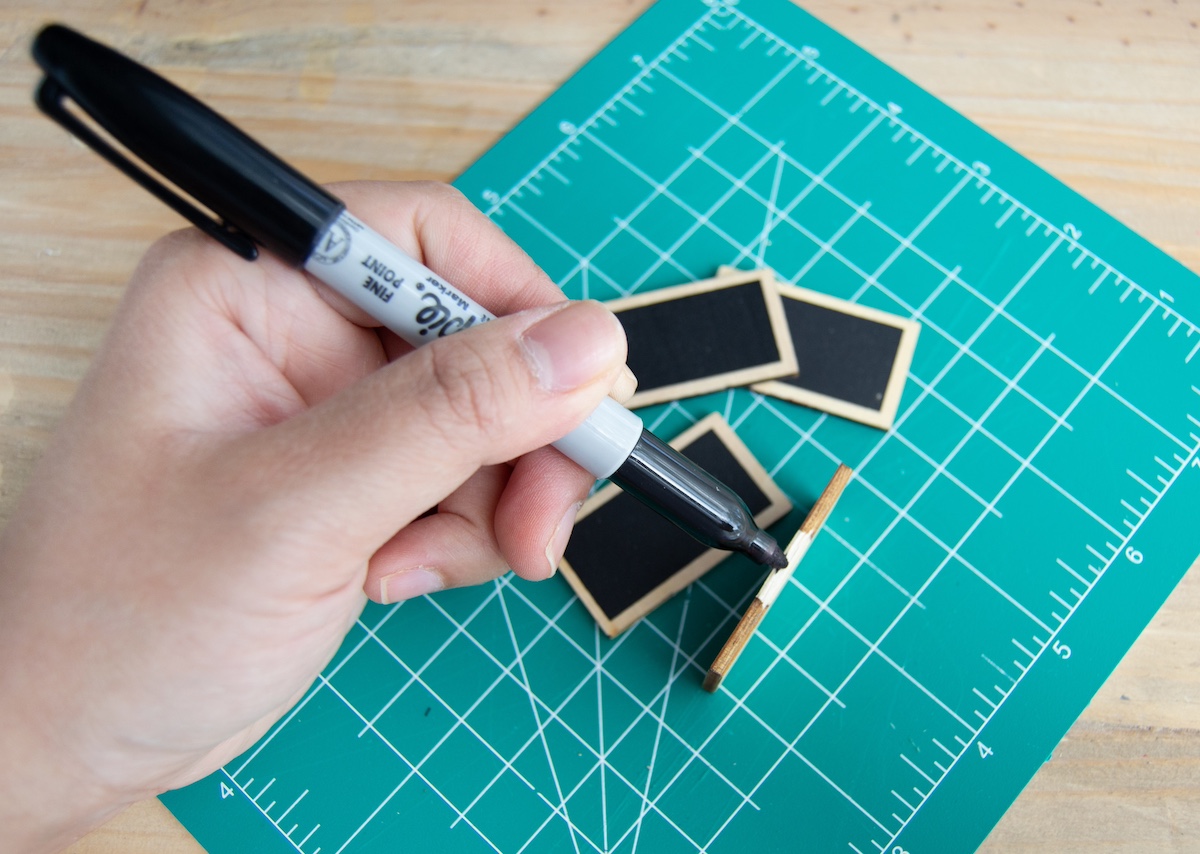 Coloring the edges of the wood tags with Sharpie