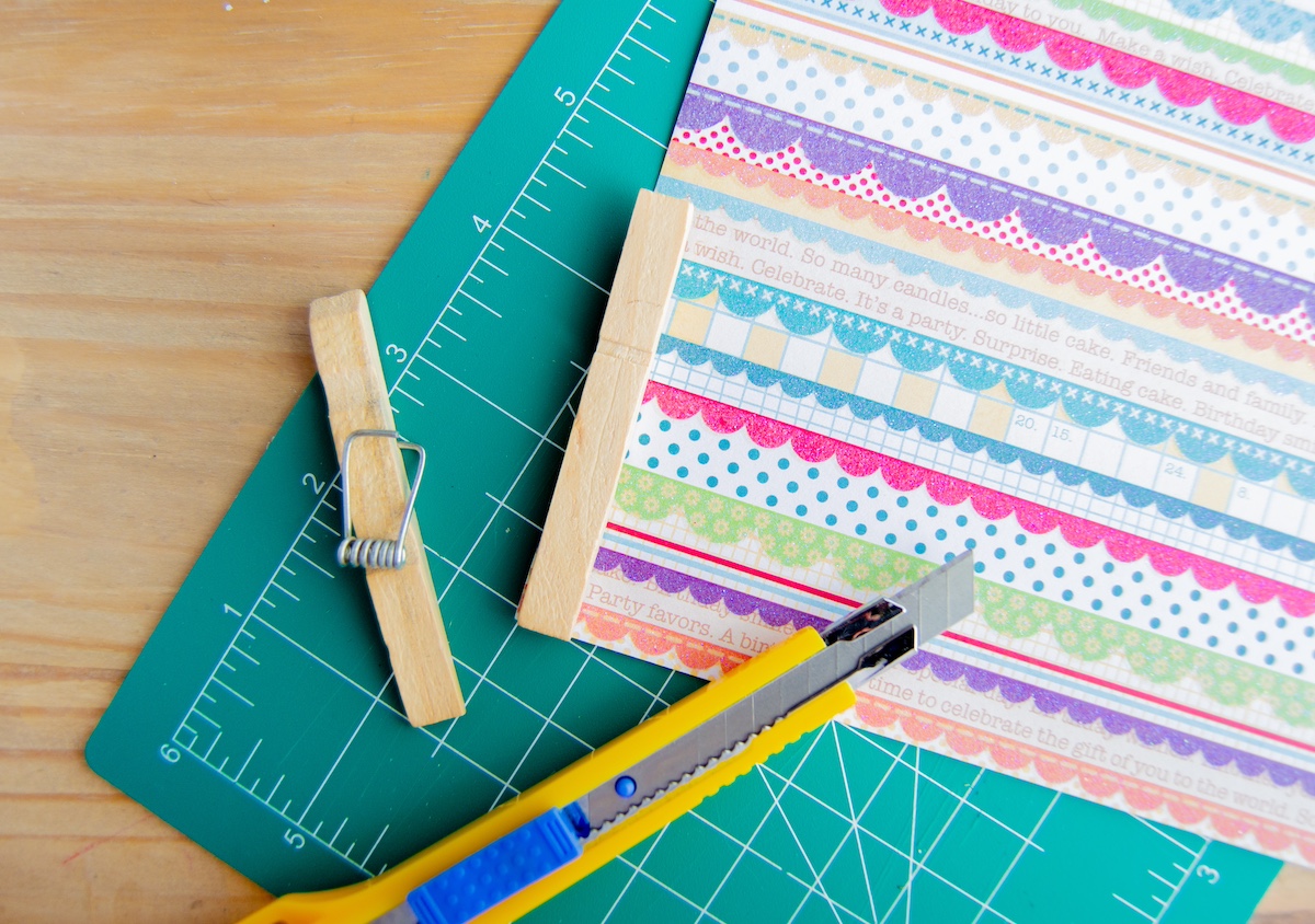 Cutting the paper to fit the clothespins