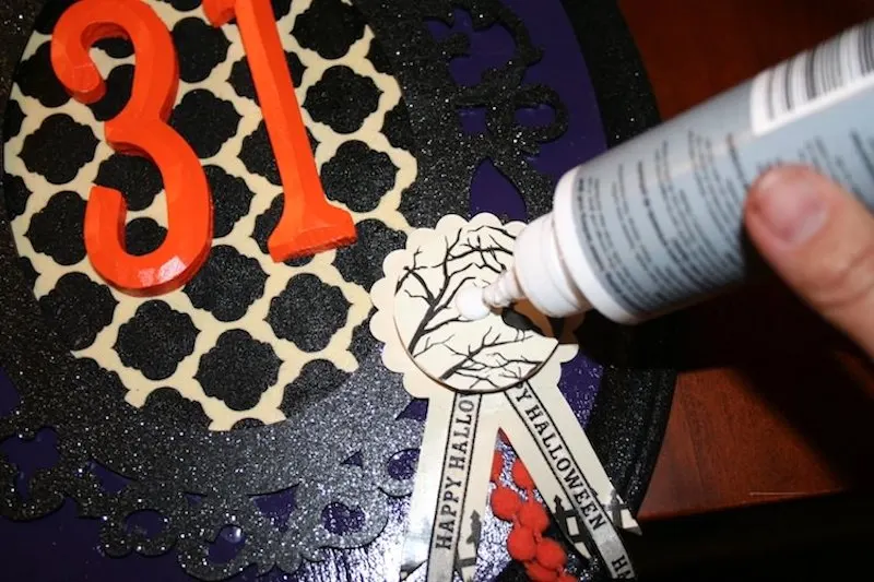 Add an accent to your Halloween plaque with glue