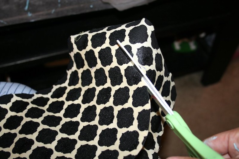 Cutting the fabric with scissors