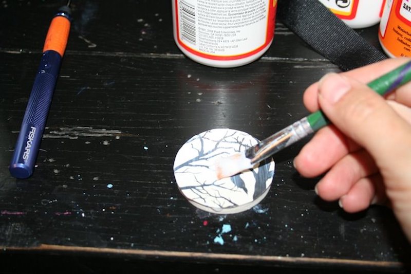 Mod Podge Halloween paper to a wood circle