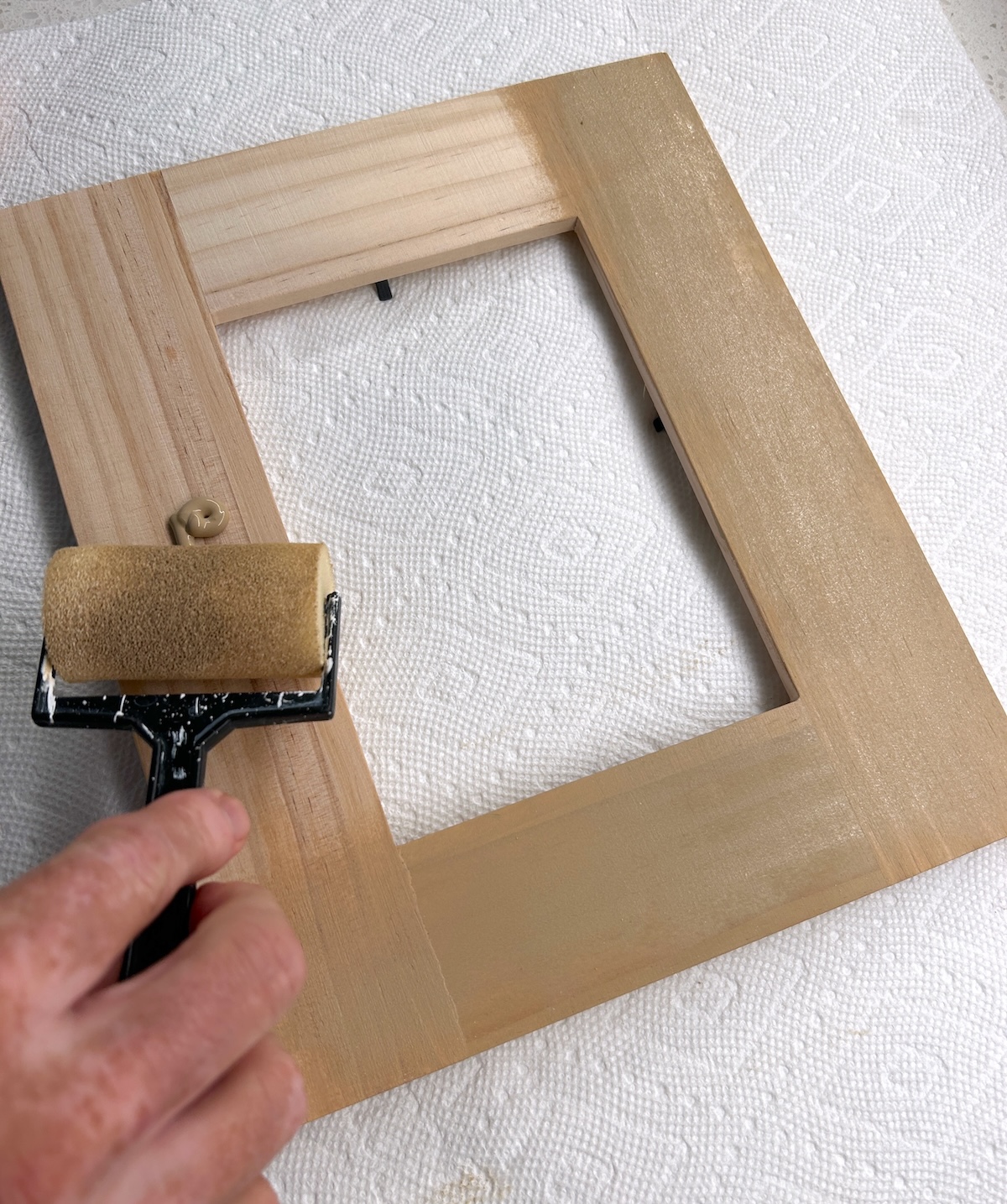 Painting the frame with a foam roller