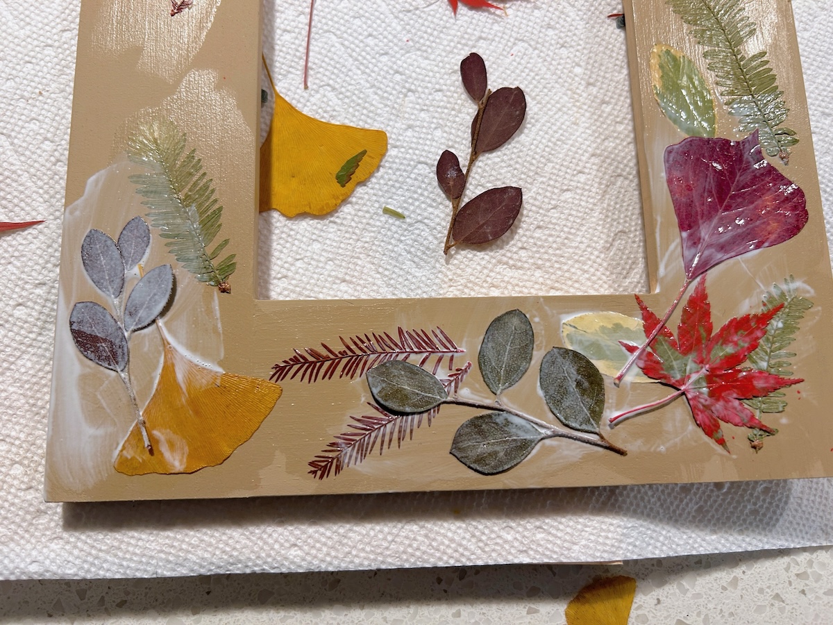 adding a final layer of leaves to the frame