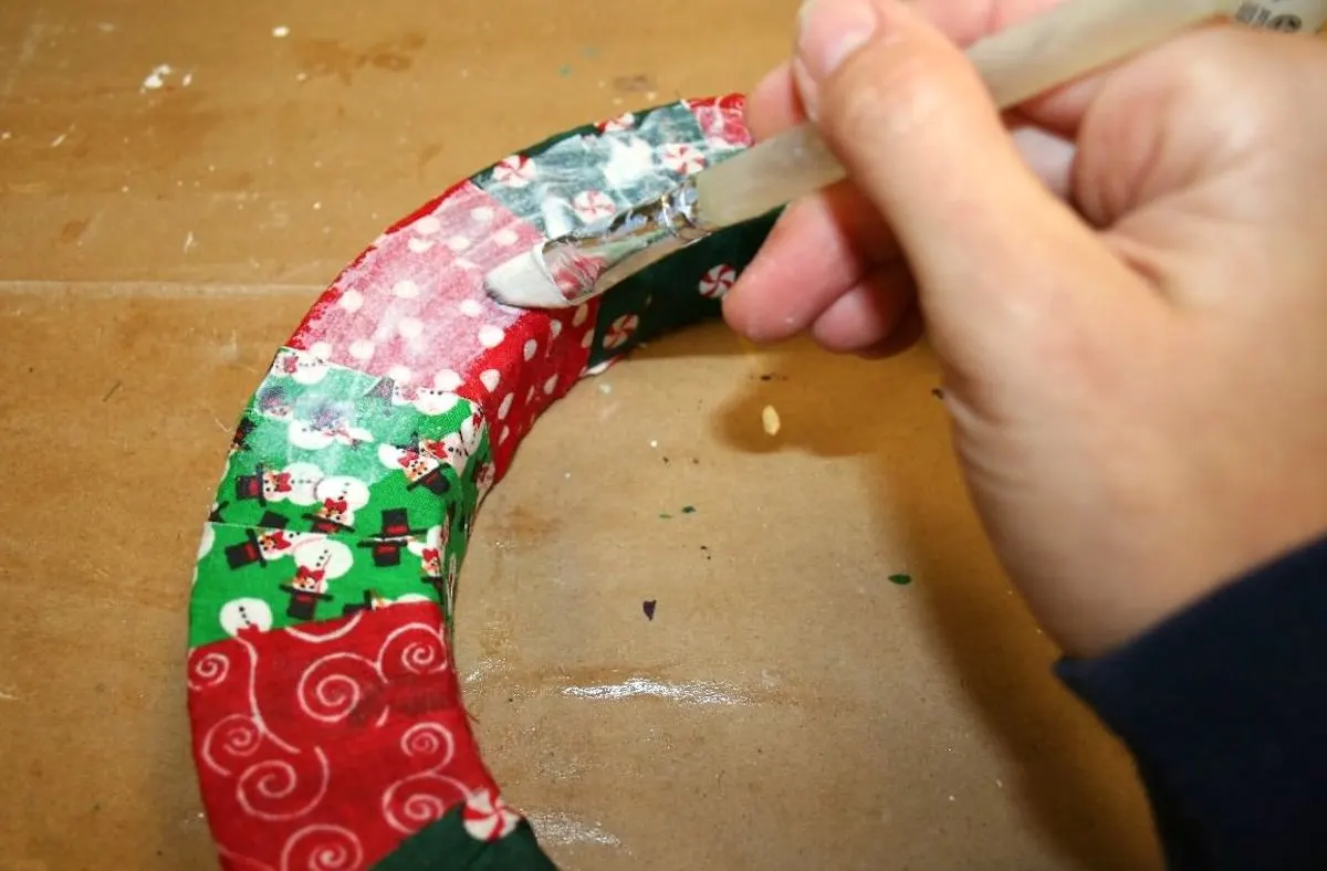 Applying Sparkle Mod Podge over the top of the fabric
