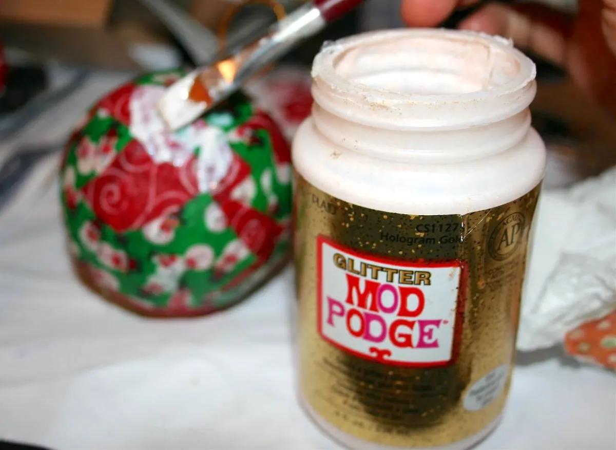 Bottle of Glitter Mod Podge and a Mod Podge ornament