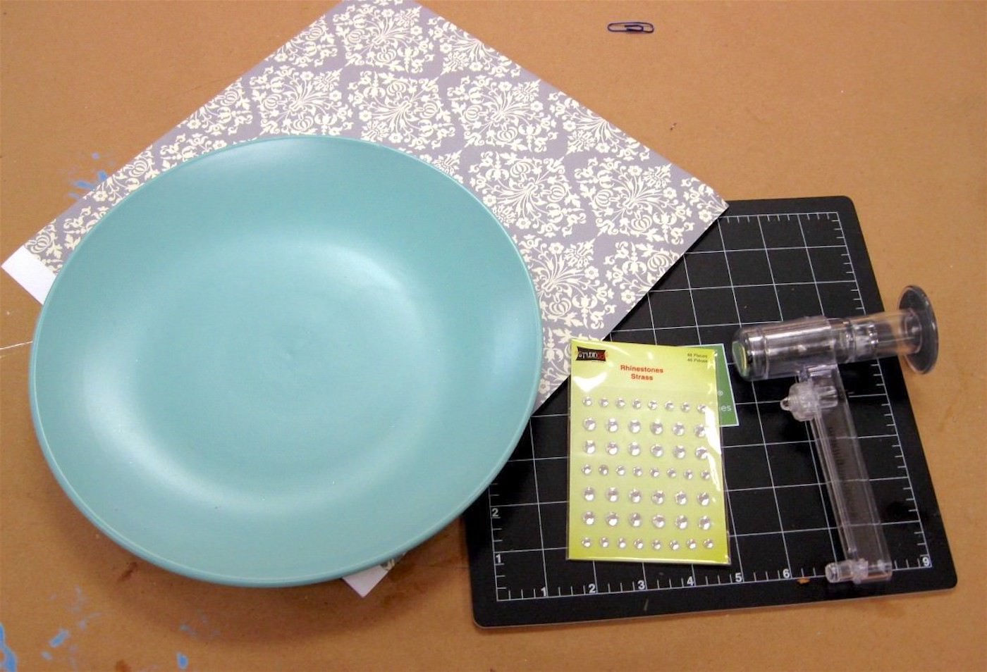 Dollar store plate, rhinestones, paper, circle cutter