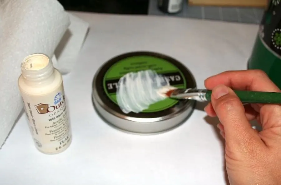 Painting a cookie tin lid with outdoor paint