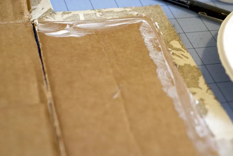 Cardboard flap pressed into the fabric
