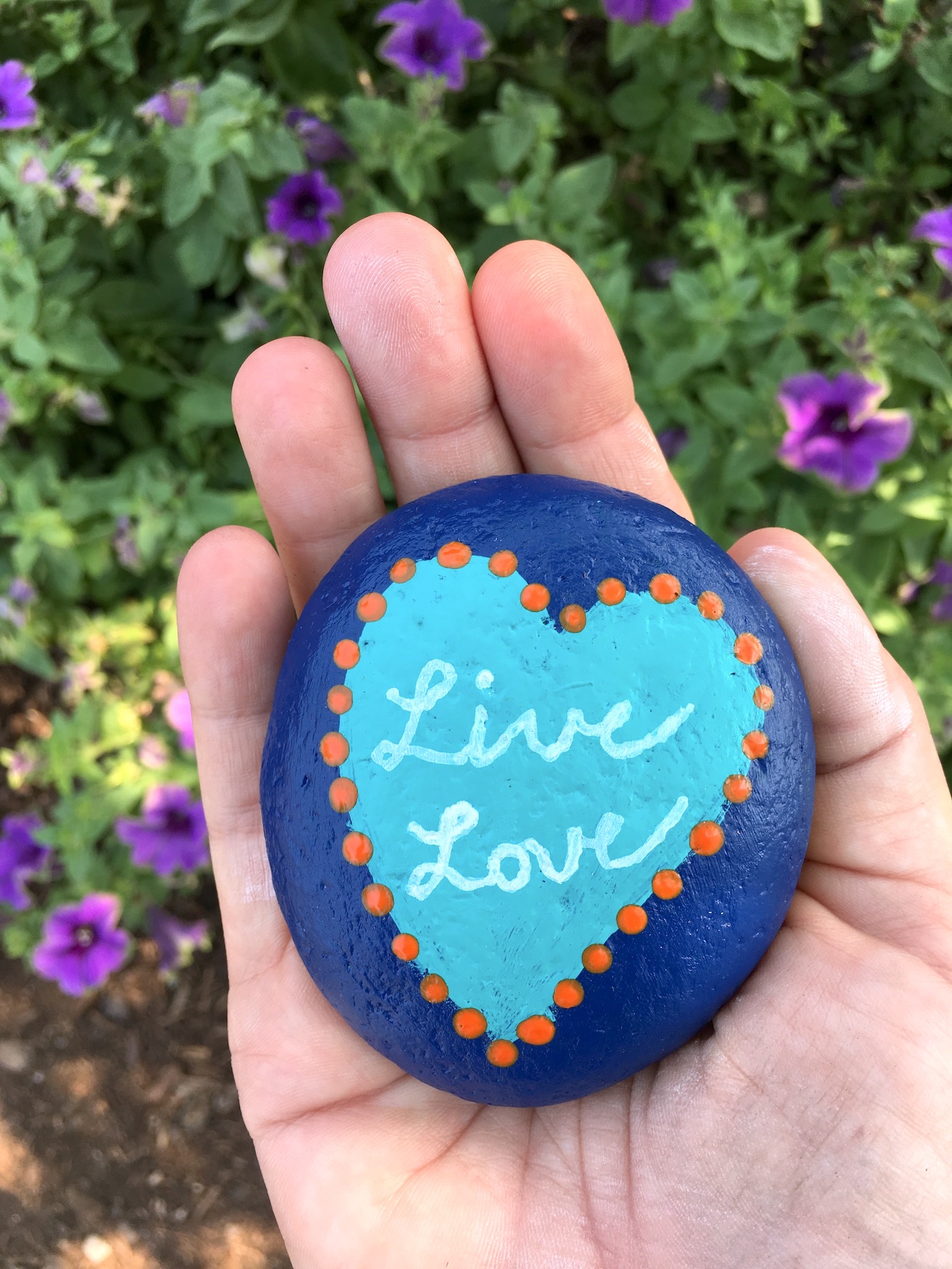 hand holding a painted rock