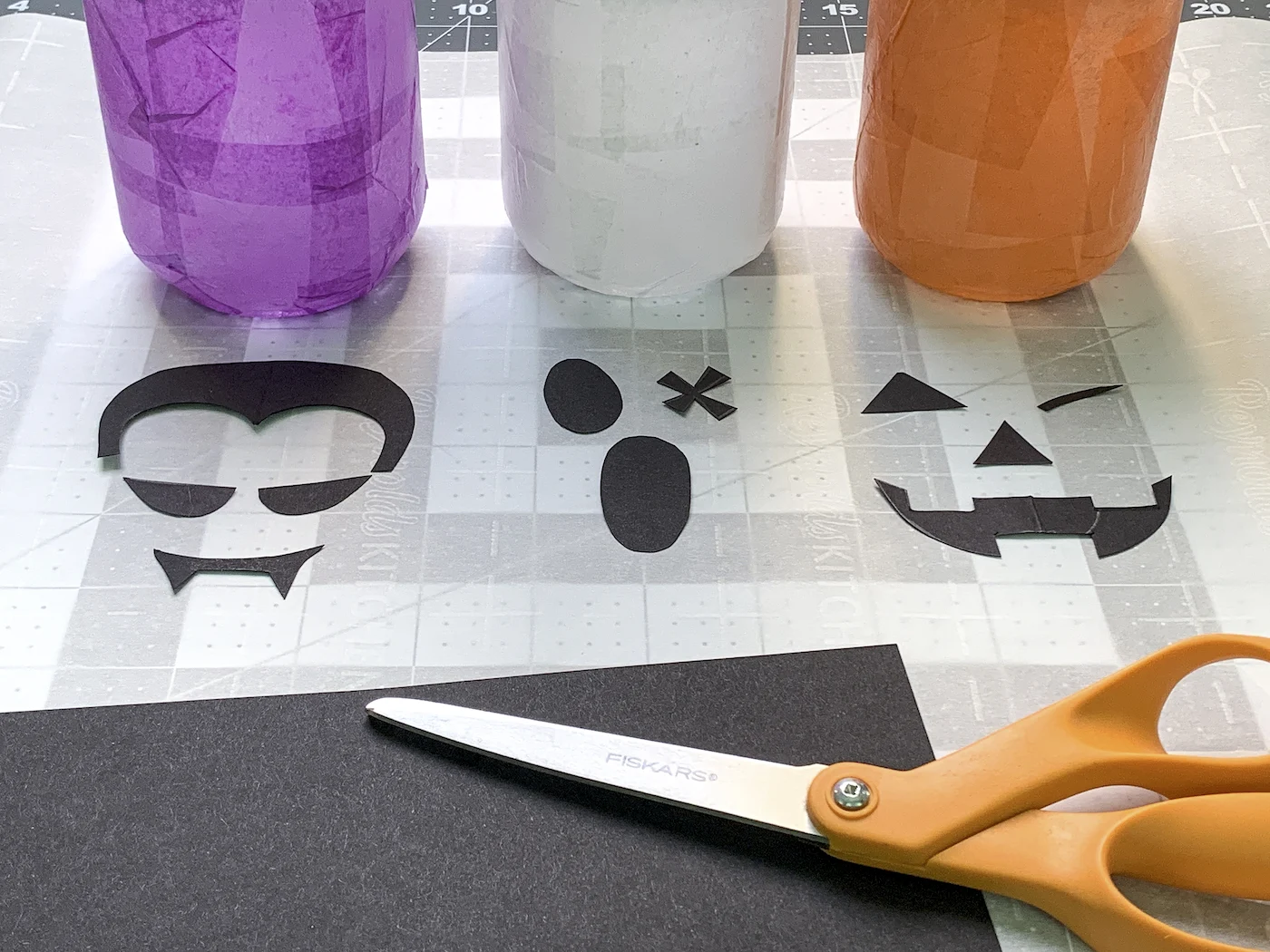 Dracula ghost and pumpkin faces cut out of black cardstock
