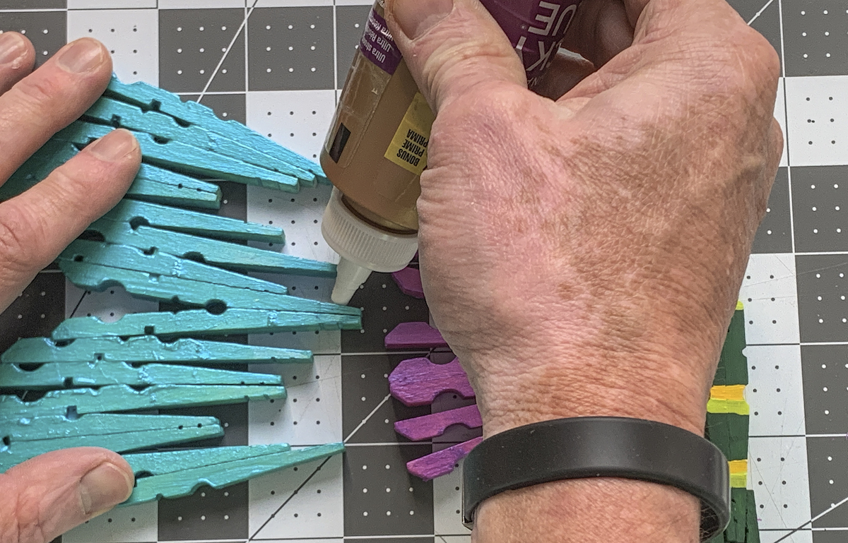 Gluing the wings of the clothespin dragonflies