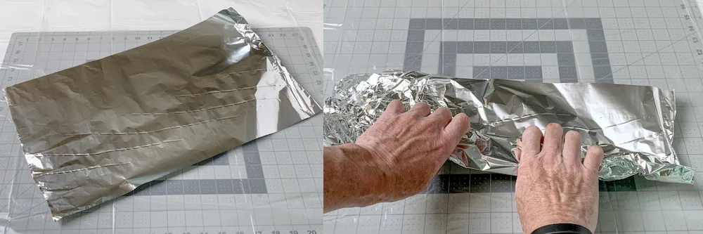 Hands rolling aluminum foil into a tight roll