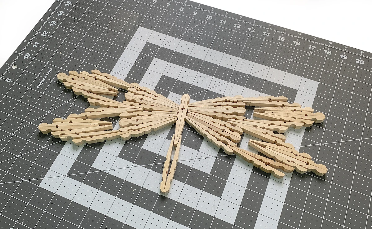 Unfinished wood clothespins shaped like a dragonfly