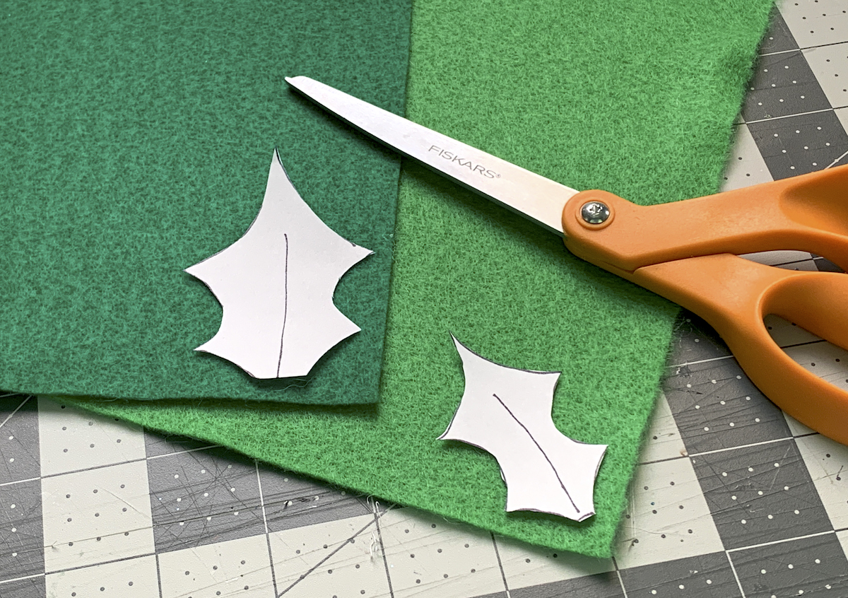 Cutting holly out of green felt using paper templates