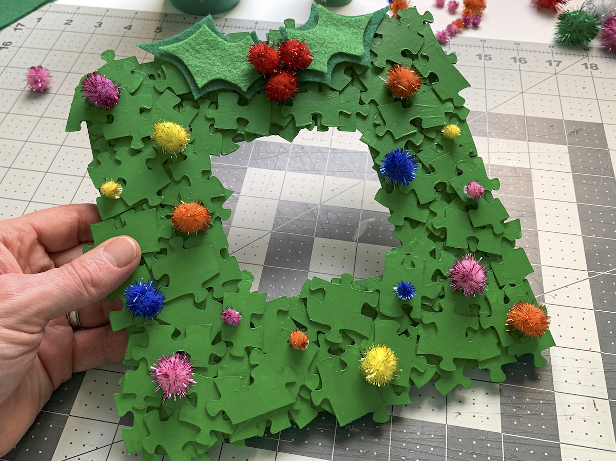 puzzle piece Christmas photo frame with glued on pom poms