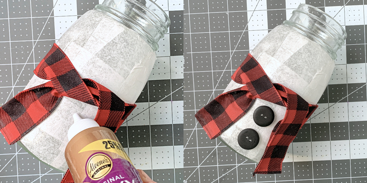 Gluing black buttons to the front of the mason jar