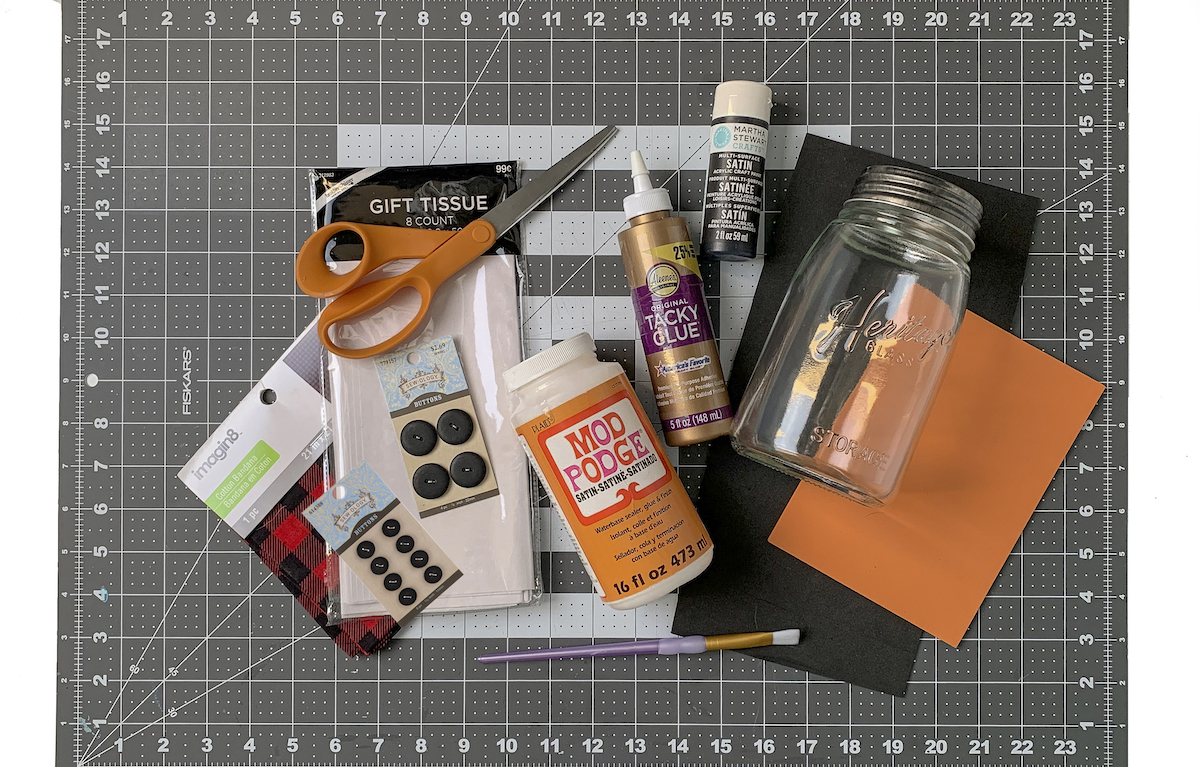 Mason jar, tissue paper, plaid bandana, buttons, scissors, craft foam, Mod Podge, craft glue, craft foam, paintbrursh