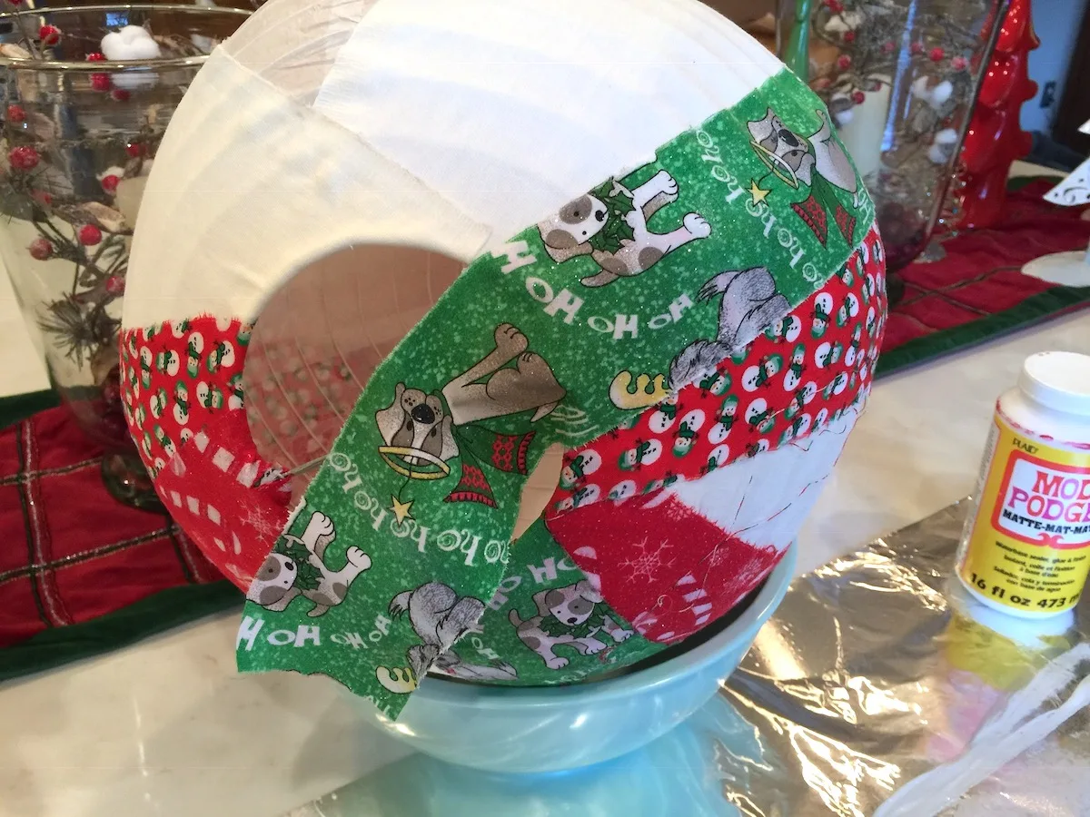 Continue applying strips of fabric with Mod Podge to the paper lantern