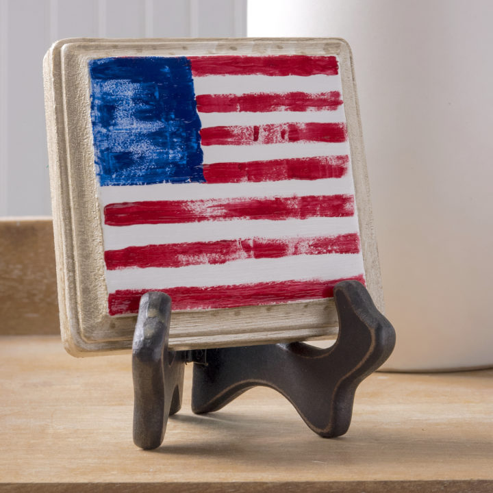 Finger painted American flag on a wood plaque