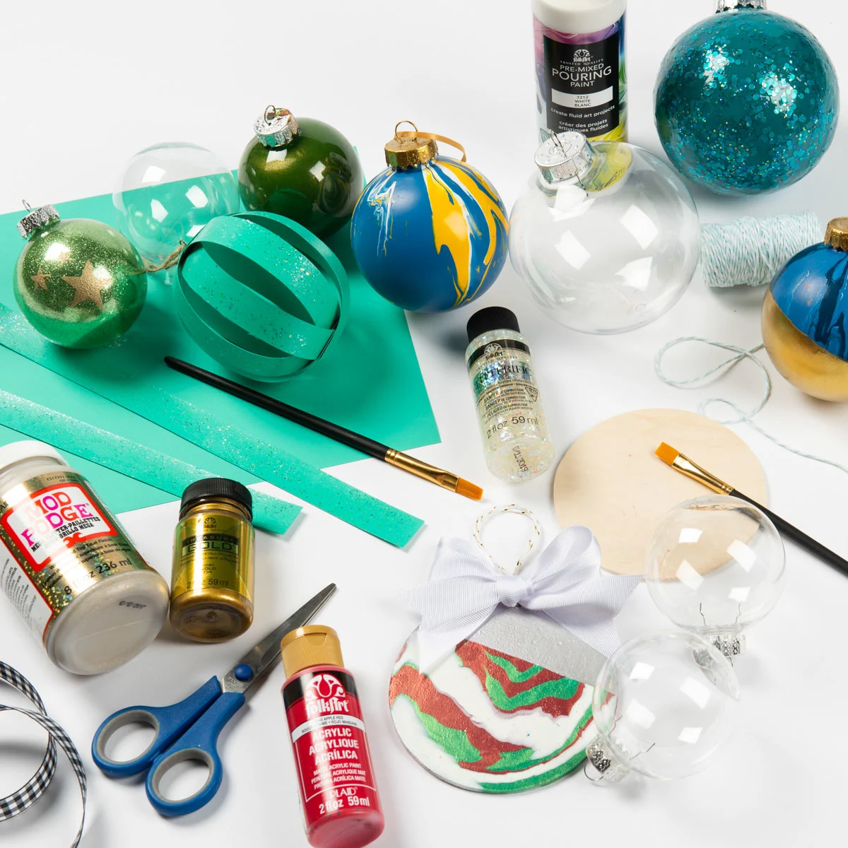 Supplies to make glitter Christmas ornaments