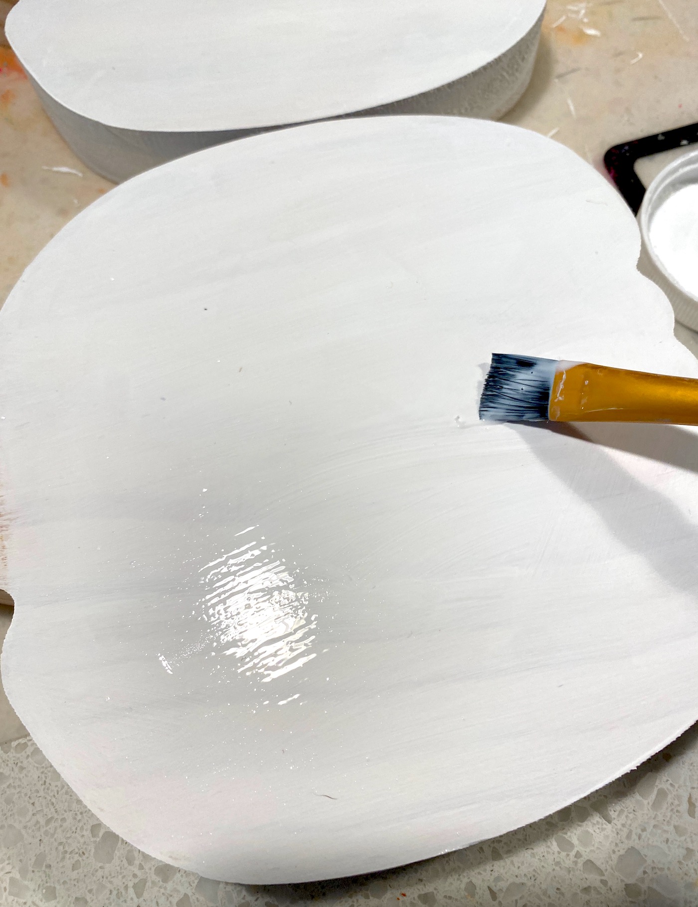 Adding Mod Podge to the top with a paintbrush