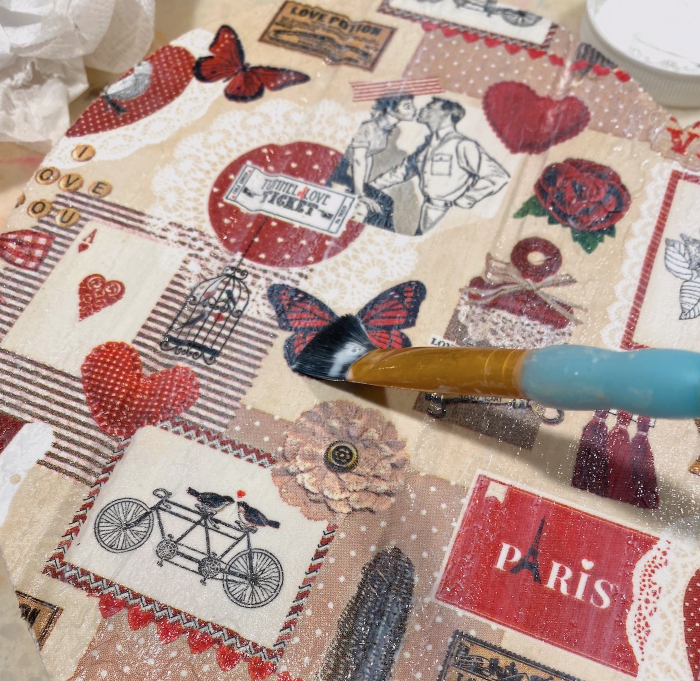 Applying Mod Podge to the top of the napkin