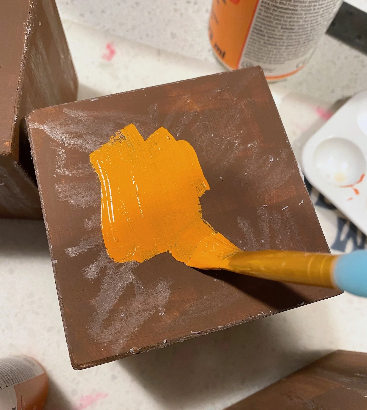 Painting over the brown with orange paint