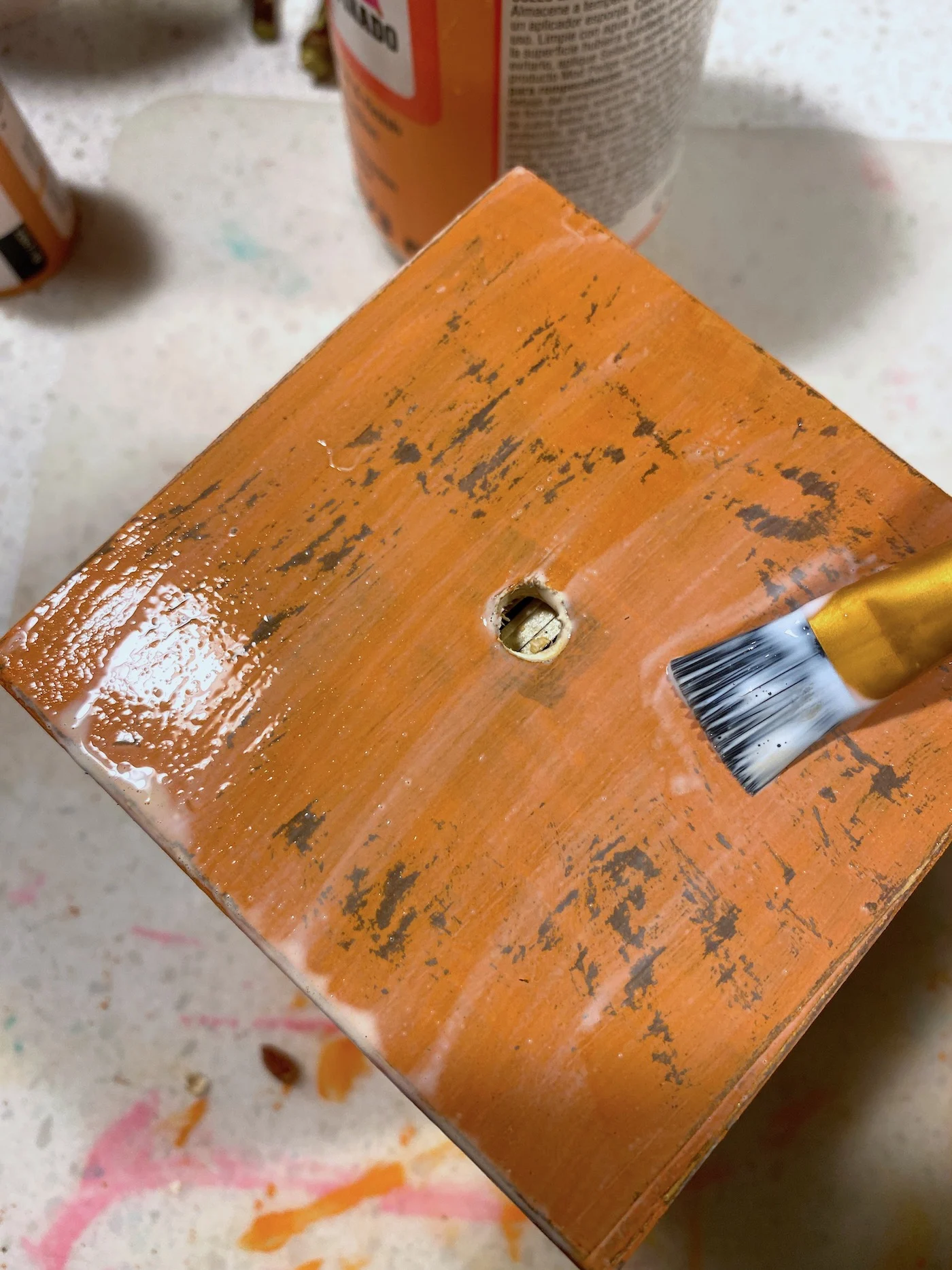 Painting the wood block with Mod Podge Satin