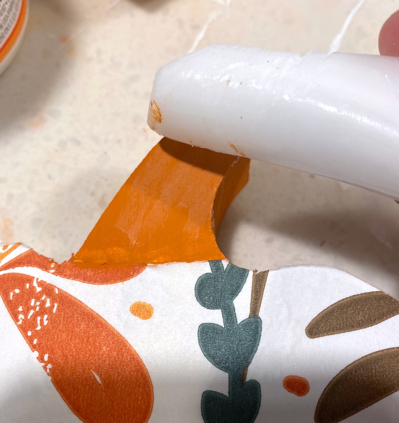 Rubbing a candle on the stem of the pumpkin