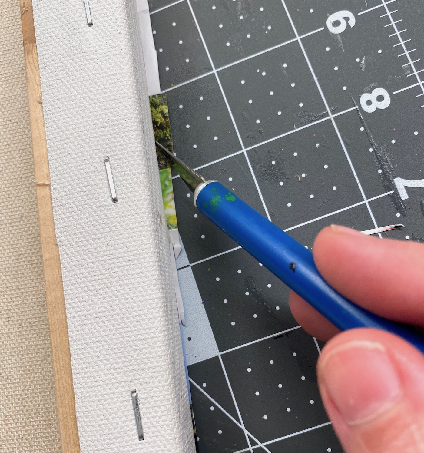 Trim the back of the canvas with a craft knife
