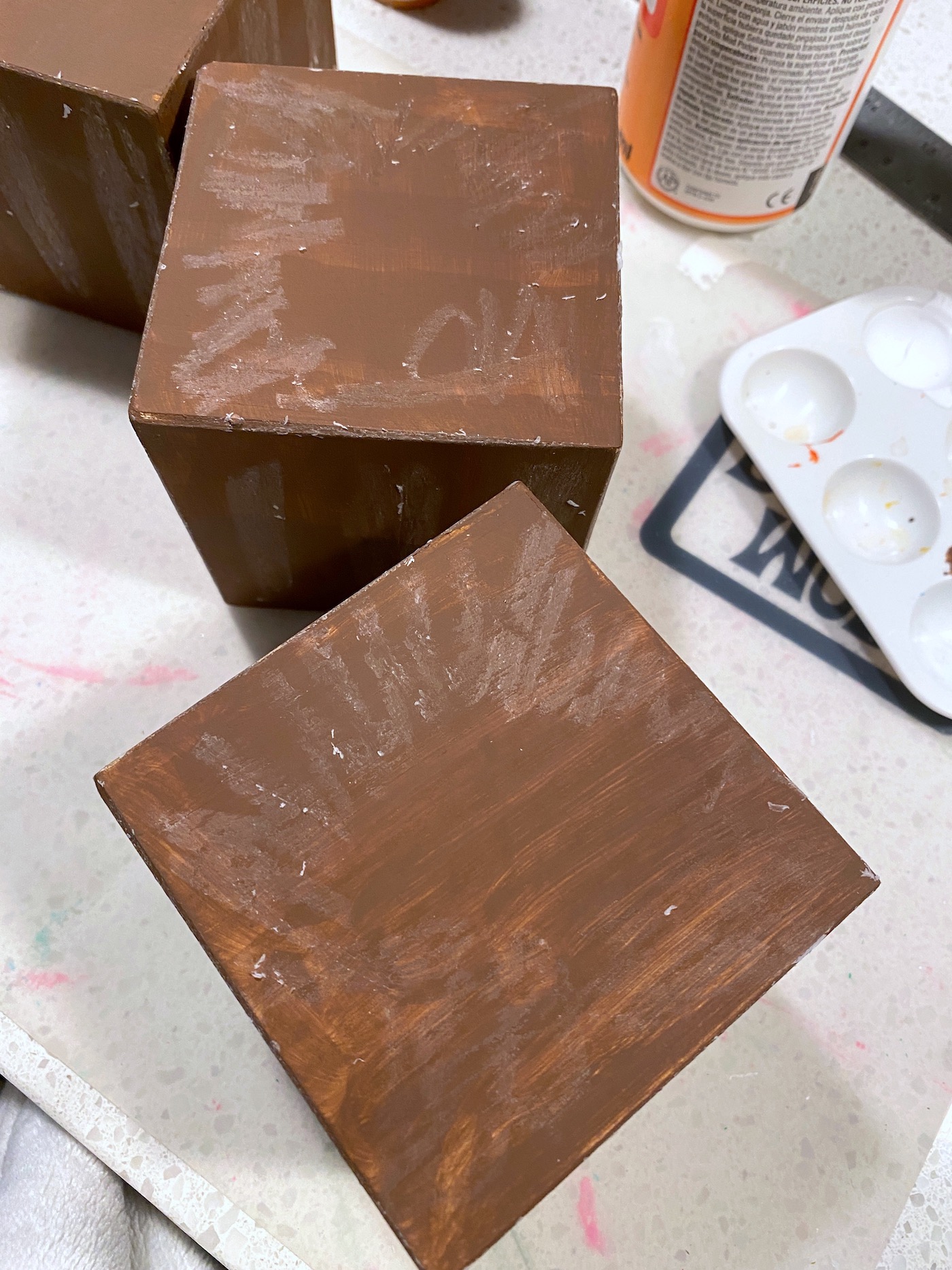 Wax rubbed onto the painted brown wood blocks